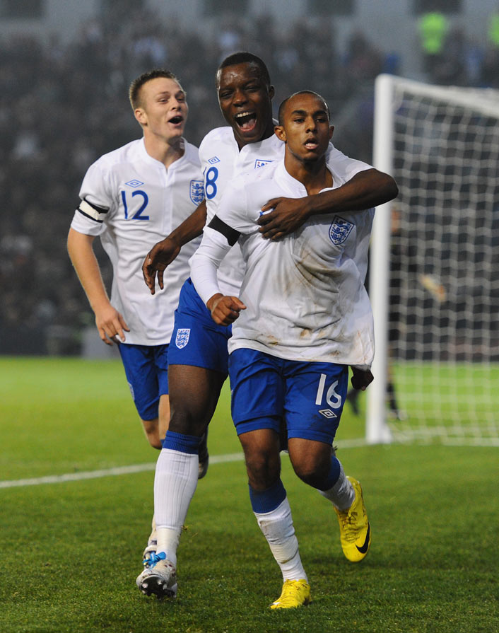 Rob Hall (right) is congratulated by Aziz Deen Conteh (centre) and Todd Kane (left) after scoring the winner against Denmark at Brighton's Amex Stadium.
